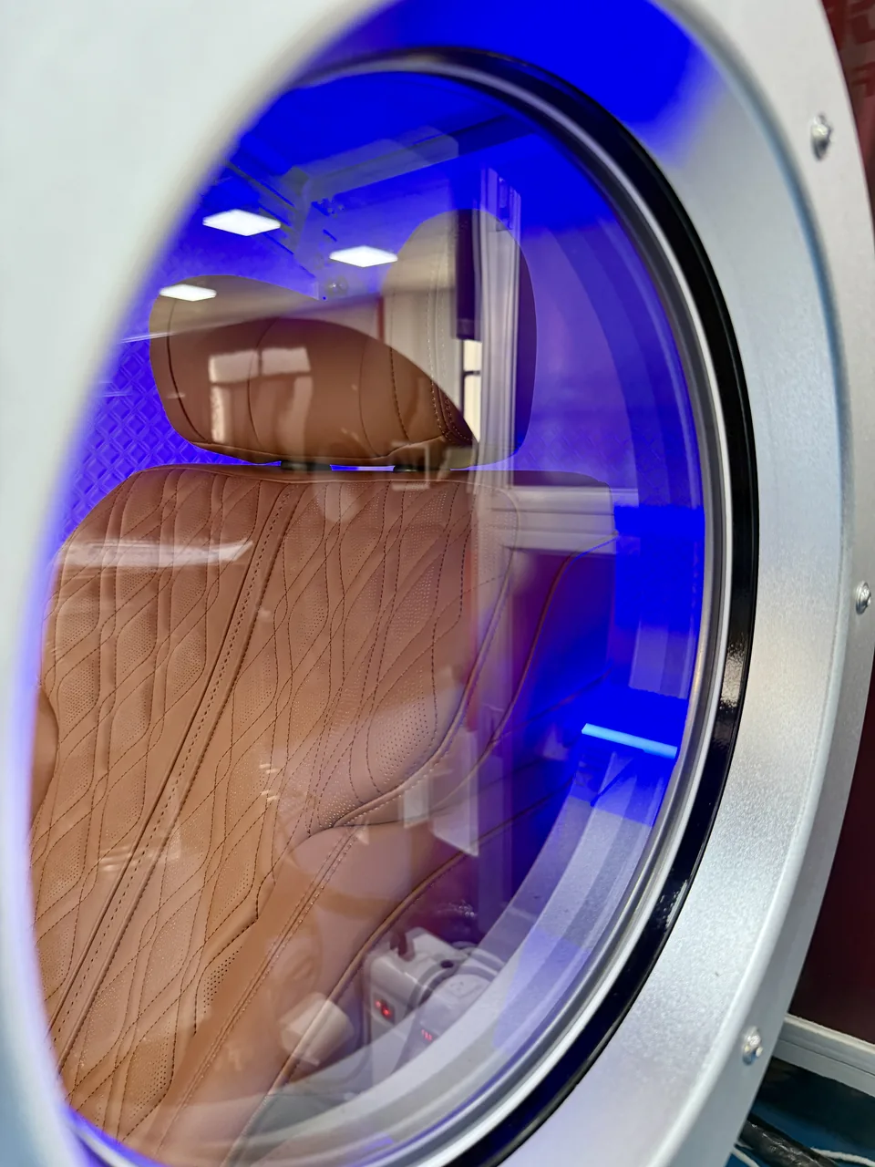 Blue ambient light seen through a porthole